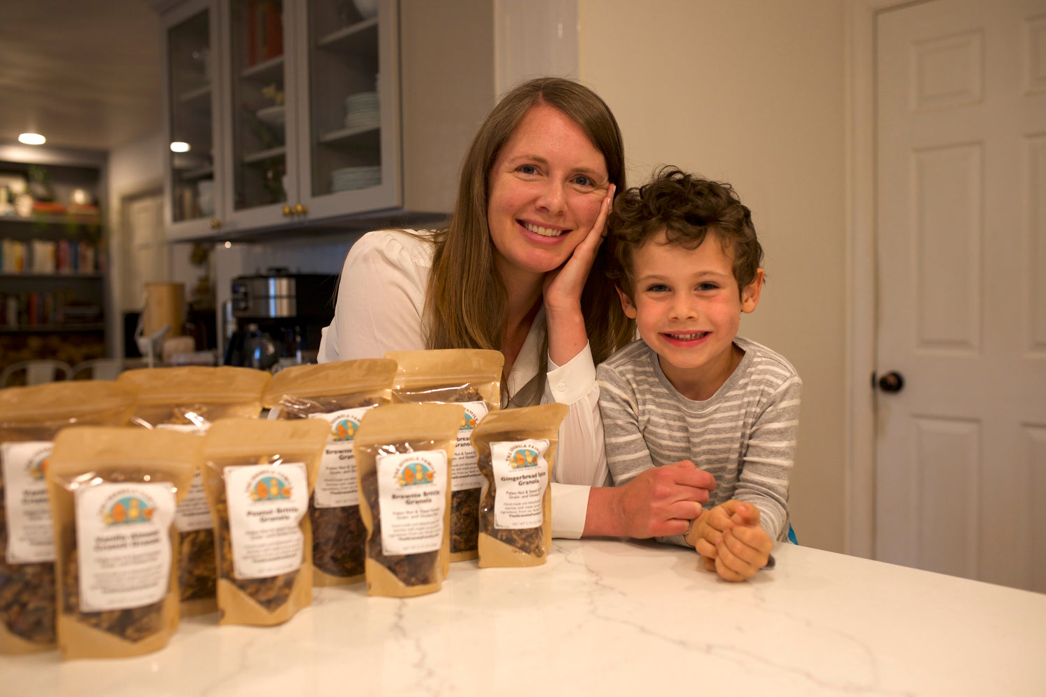 Woman and child with bags of coffee beans on a kitchen counter